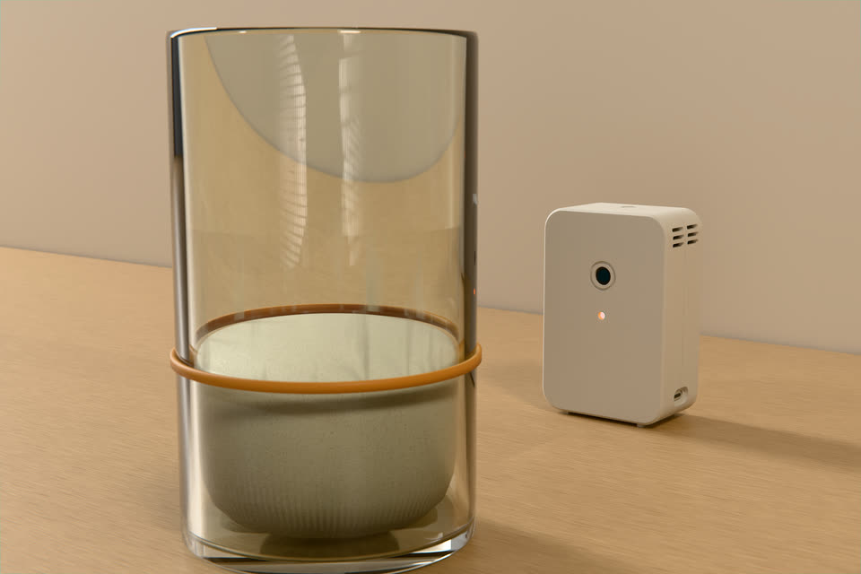 The white R-01 on a maple counter, its eye aimed at a glass jar of starter with an orange rubber band marking the starting level.